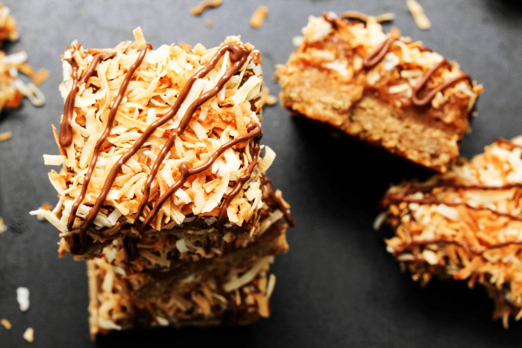 Healthy Girl Scout cookies do exist! Make a batch of these high protein, vegan, gluten free Samoa Cookie Bars for a healthy dessert when your cravings strike.