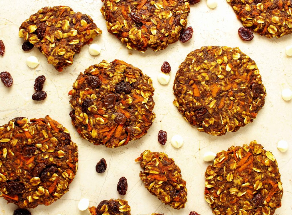 This delicious healthy recipe for carrot cake cookies is so quick and easy you may never make a traditional carrot cake again. These cookies are also high in protein so they make a great post workout or afternoon snack! #postworkout #carrotcake